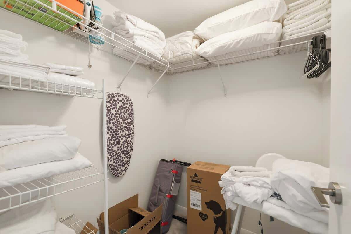 A roomy walk-in closet with extra linens, hangers and an iron for longer stays.