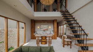 A modern interior with a kitchen, dining area, and a staircase. - Cozy villa, prime Uluwatu, actual walking distance (Badung Regency)