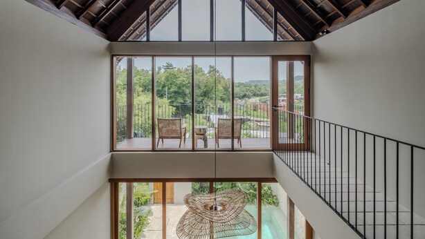 A modern interior with a high ceiling, large windows, and a view of greenery outside. - Cozy villa, prime Uluwatu, actual walking distance (Badung Regency)