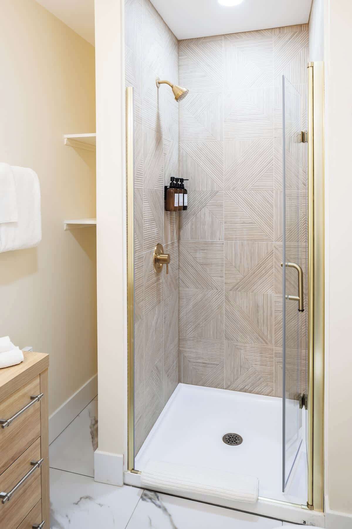 Shower, hair dryer, towels, shampoo