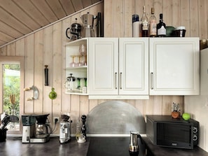 A kitchen with white cabinets, a coffee maker, a toaster, and a microwave. - Summerhouse by the Little Belt with sea view (Haderslev)