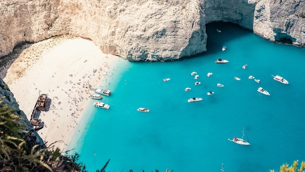 A coastal area with boats, a beach, and rocky cliffs. - Villy Suites II - Zante Lux Suite Near the Beach (Zakynthos)