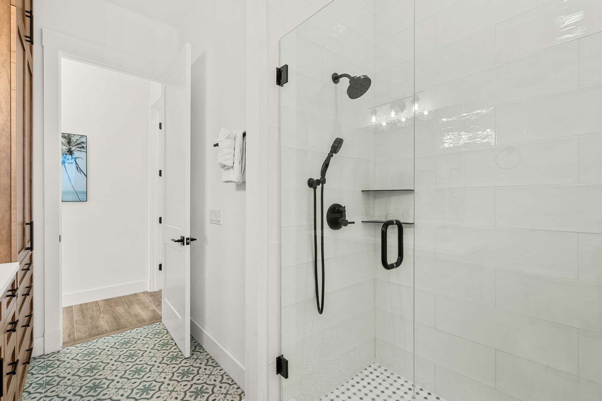 A bathroom with a shower, a toilet, and a sink.