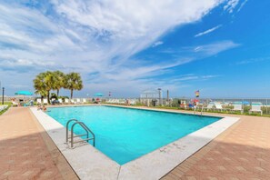 A rectangular swimming pool with a metal ladder on one side, surrounded by a paved walkway. - Super Clean, Pool, Beach, Dining, Fun (Orange Beach)