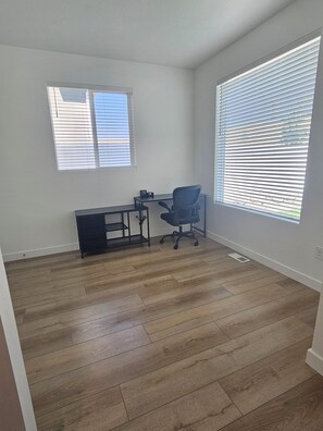 A room with a desk, chair, and two windows with blinds. - Spacious 5-bedroom Family Home in West Jordan~4 Parking Spots~Quite+Clean (West Jordan)