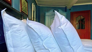 A bed with white pillows and a dark headboard. - Historic stay in the heart of Aeroskobing (Ærøskøbing)