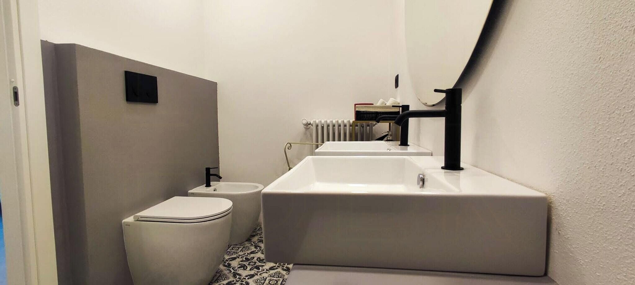 A compact bathroom with a toilet, a sink, and a bathtub.