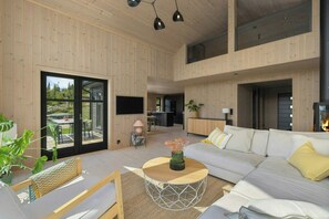 A modern interior with a sofa, coffee table, and a fireplace.