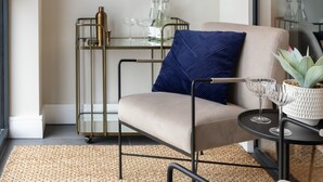 A modern living room with a sofa, a glass table, and a large window. - Spacious 3BR Near Bullring | StayCozy (Birmingham)