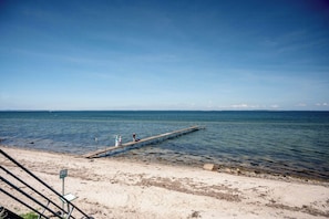 A pier extending into calm waters with a clear sky. - Nordals home with panoramic views of Lillebaelt (Nordborg)