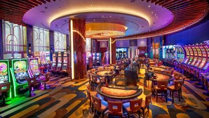 A casino with slot machines, blackjack tables, and a vibrant, modern interior.