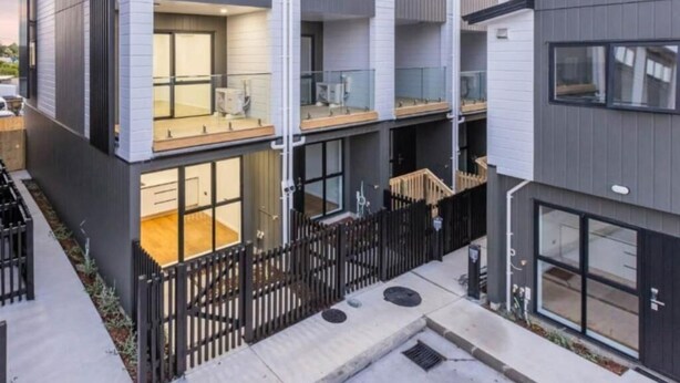 A multi-story residential building with balconies, large windows, and a gated entrance. - Stylish Wesley Retreat (Auckland)