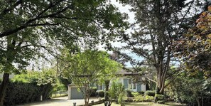 Ein Haus, umgeben von Bäumen und einem Garten.