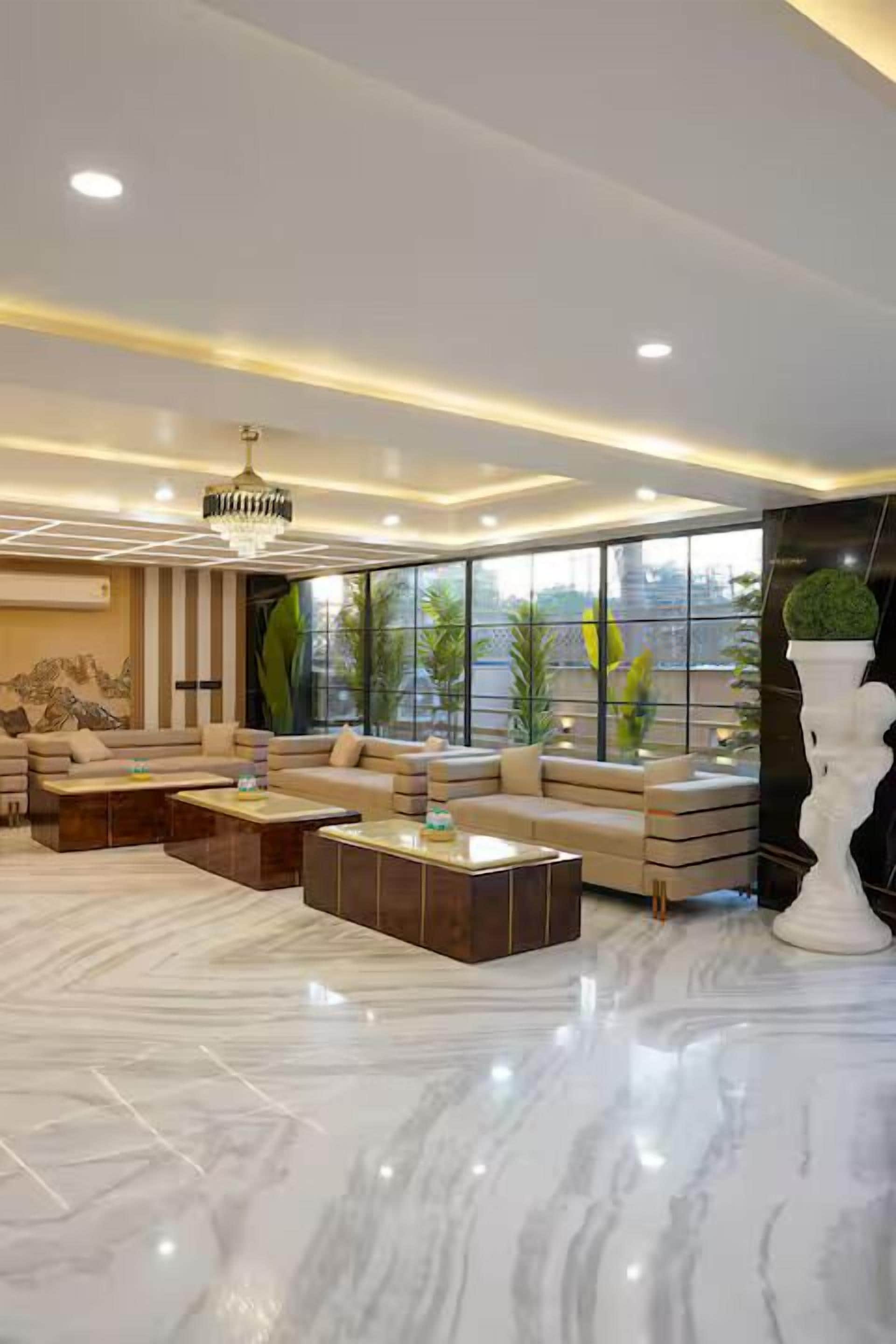 A modern living room with a sofa set, coffee tables, and a large window with a view.