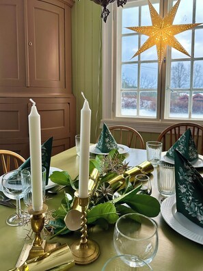 A dining table set with candles, glassware, and decorative foliage. - Charming farmhouse from 1919 near Kristiansund (Kristiansund)