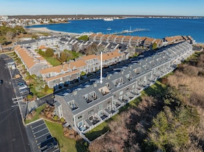 A coastal residential area with modern apartment buildings, a marina, and a beach.