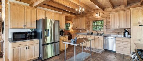 A spacious kitchen with wooden cabinets, stainless steel appliances, and a large island.