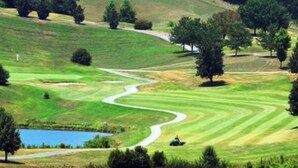 A golf course with a winding path, a pond, and trees. - Perfect Norris Lake 2Br condo in Deerfield Resort with amazing lake views! (LaFollette)