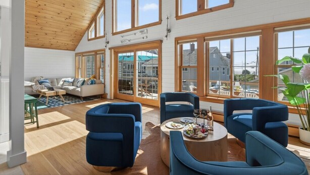 A spacious loft with high ceilings, large windows, and a cozy seating area. - The Apex at Moody: Sun-Filled Beach House (Wells)