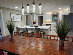 A modern kitchen with white cabinets, a central island, and pendant lighting. - HUGE 5bd/4ba Pool/Spa Sleeps 14+ Bunks USSSA (Melbourne)