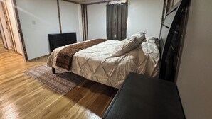 A bedroom with a bed, a dresser, a desk, and a ceiling light. - CountryComfortRetreat!!! 2-bedroom mobile home with AC in Birch Tree (Birch Tree)