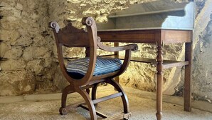 A wooden chair with a patterned cushion and a small wooden table with a marble top. - Renovated little house with High Alps view (Baratier)