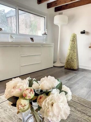 A modern kitchen with white cabinets, a wooden beam ceiling, and a large window. - Picardy house near Compiègne and Pierrefonds (Jaux)