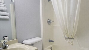 A bathroom with a sink, toilet, and bathtub.
