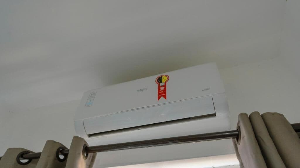 A ceiling-mounted air conditioning unit with a visible brand logo and a control panel.