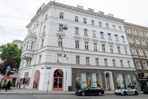 A multi-story building with a classic architectural style, featuring a ground-level entrance with a glass facade and a series of windows on the upper floors. - Blueground | Alsergrund, view, nr Votivkirche (Vienna)