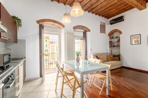 Une cuisine moderne avec un coin repas, un plancher en bois et un balcon offrant une vue agréable.