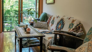 A cozy living room with a sofa, a coffee table, and a bookshelf.
