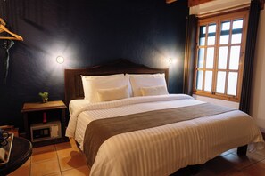 In-room safe, desk, laptop workspace, blackout drapes - Docecuartos Hotel (San Cristóbal de las Casas)