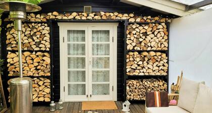 Black-painted wooden house overlooking Vejle Fjord