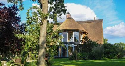 Apartment in a thatched cottage with private lake