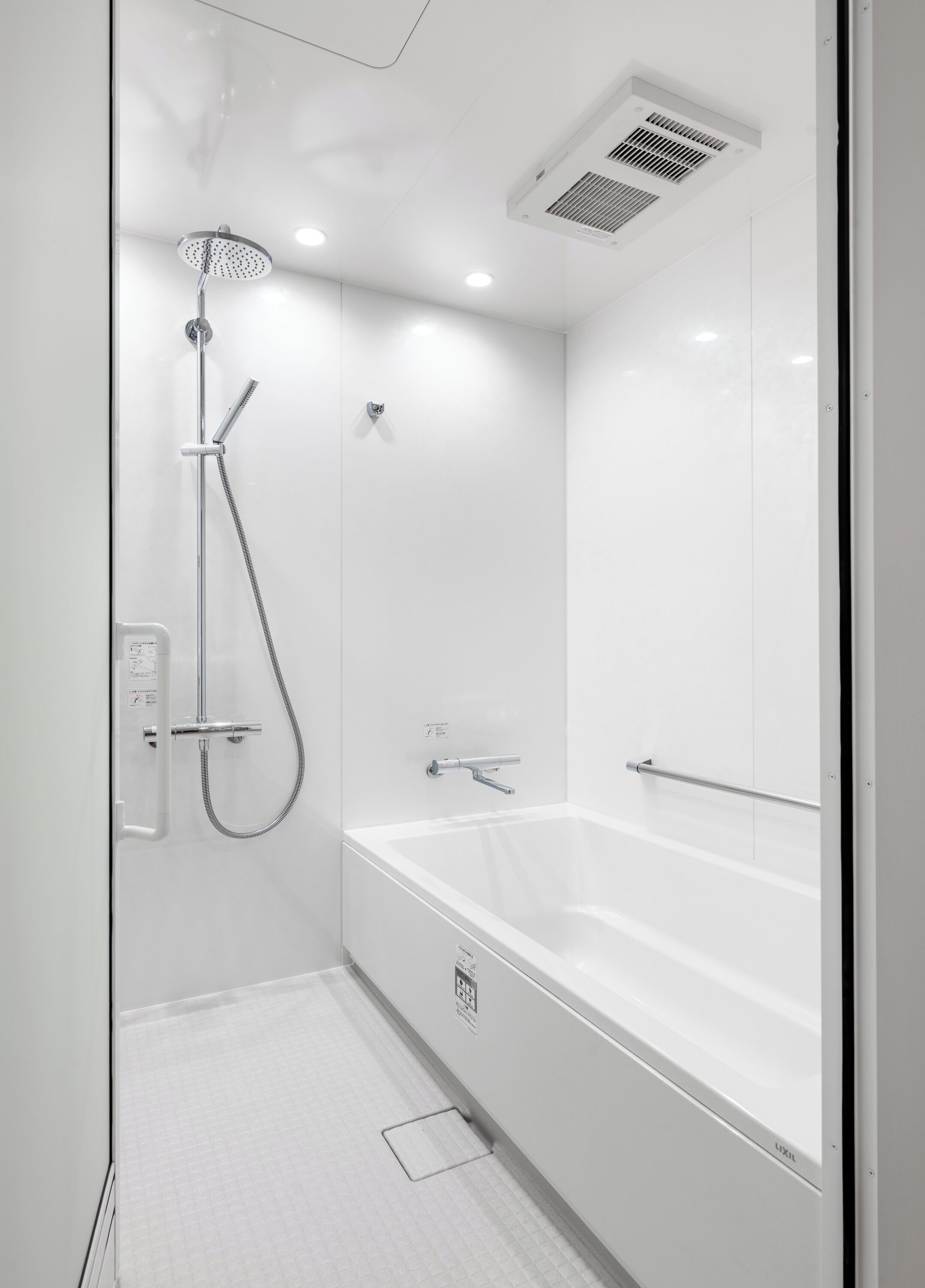 A modern bathroom with a walk-in shower, a standalone bathtub, and a wall-mounted toilet.