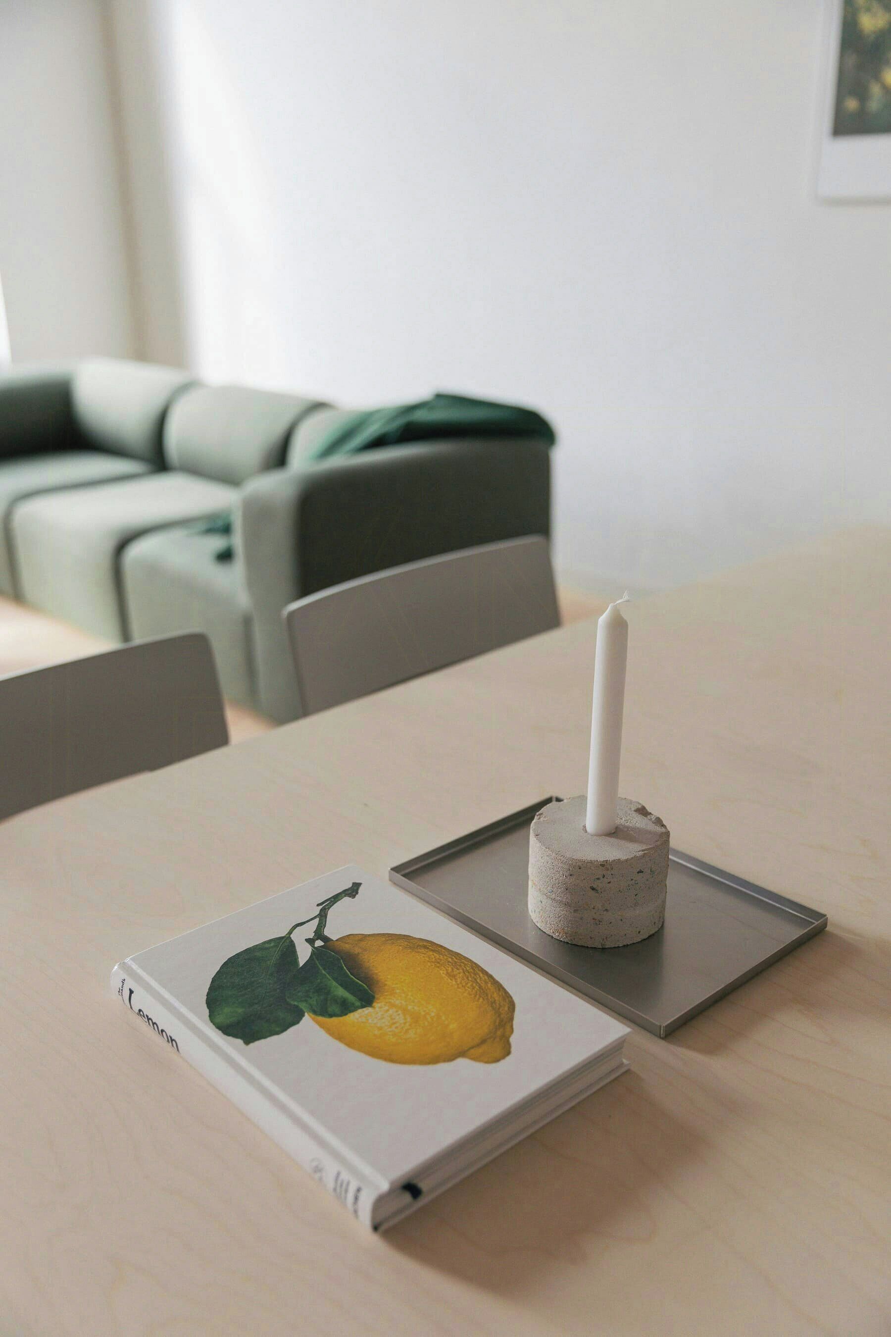 A table with a book and a candle holder.