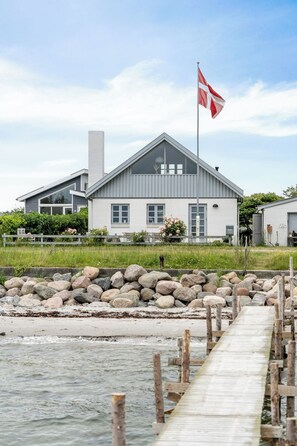 A coastal building with a dock extending into the water. - Home with views and walking distance to nature (Nyborg)