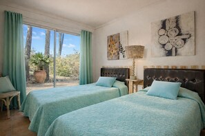 A room with two beds, a window with curtains, a potted plant, and artwork on the wall. - Authentic villa in the Var countryside (Les Arcs)