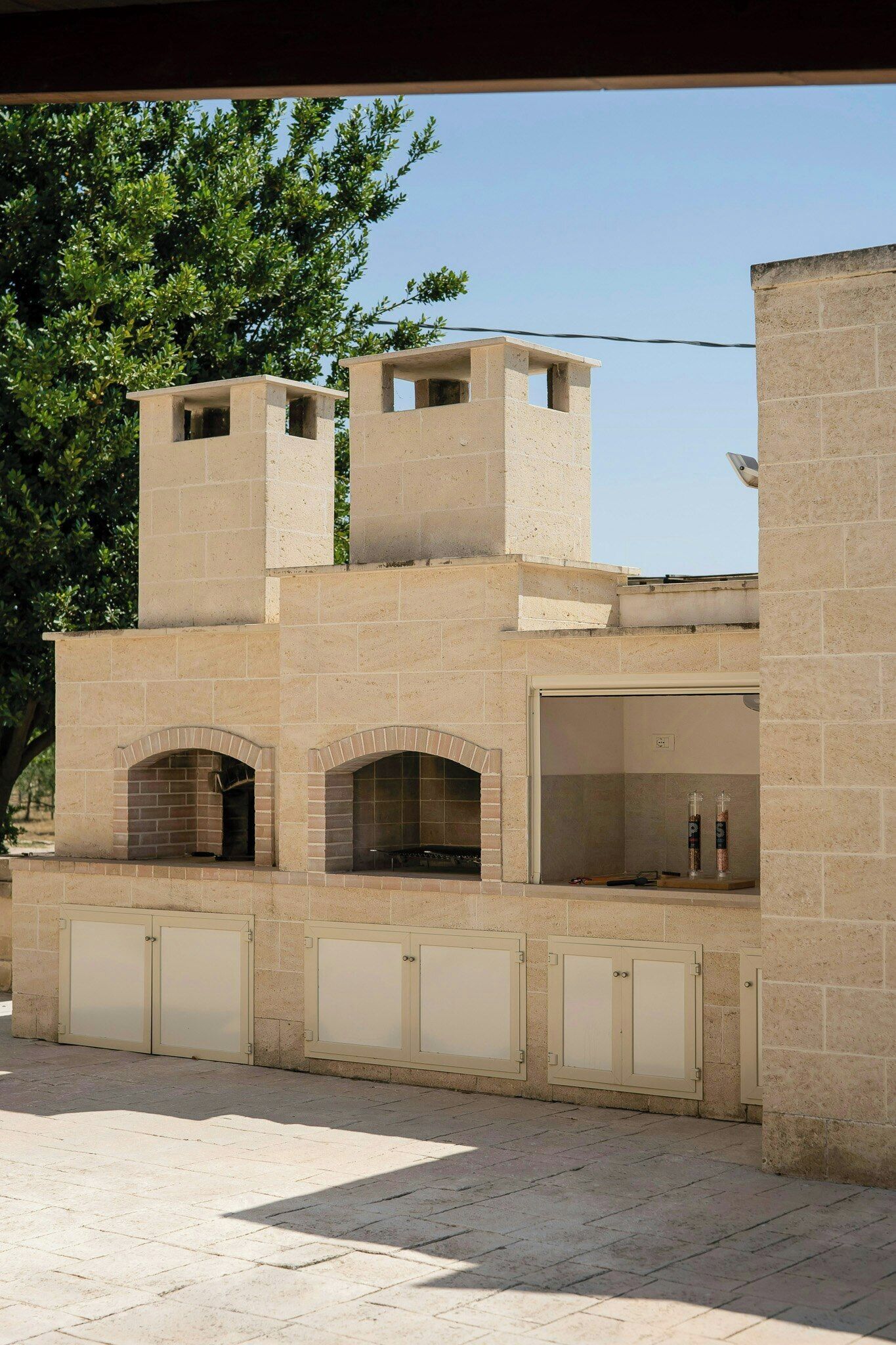 A building with a flat roof, multiple windows, and a brick facade.