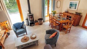 A cozy living room with a fireplace, dining area, and seating. - Charming house in an organic wine estate (Frontignan)