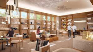 A modern library with bookshelves, seating areas, and a fireplace. - S-peria Hotel SAPPORO (Sapporo)