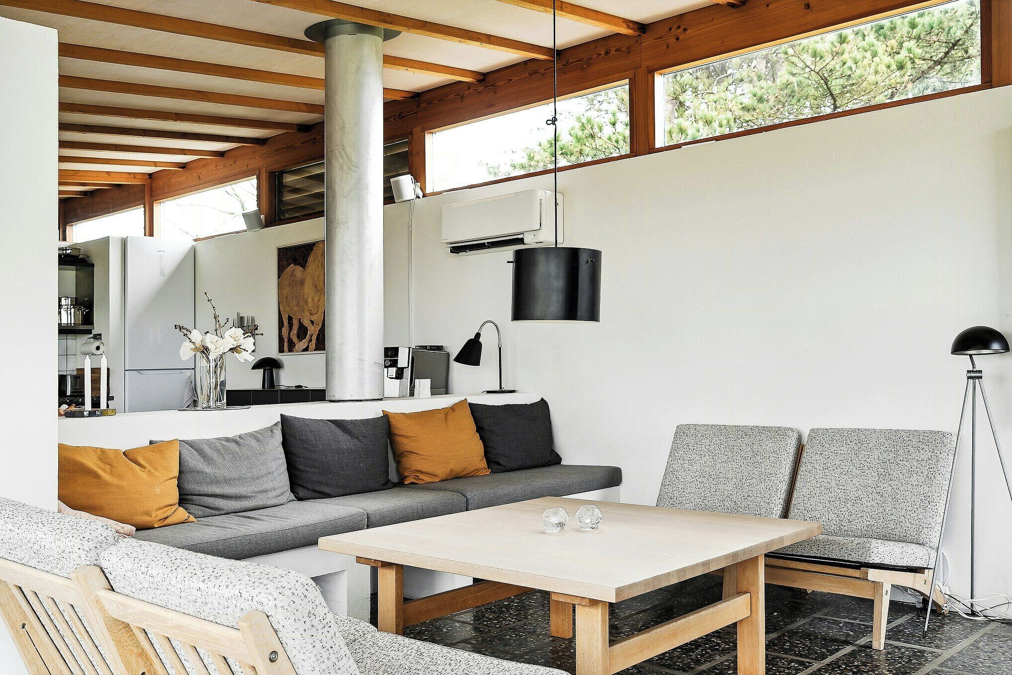 A modern living room with a sofa, a coffee table, and a lamp.