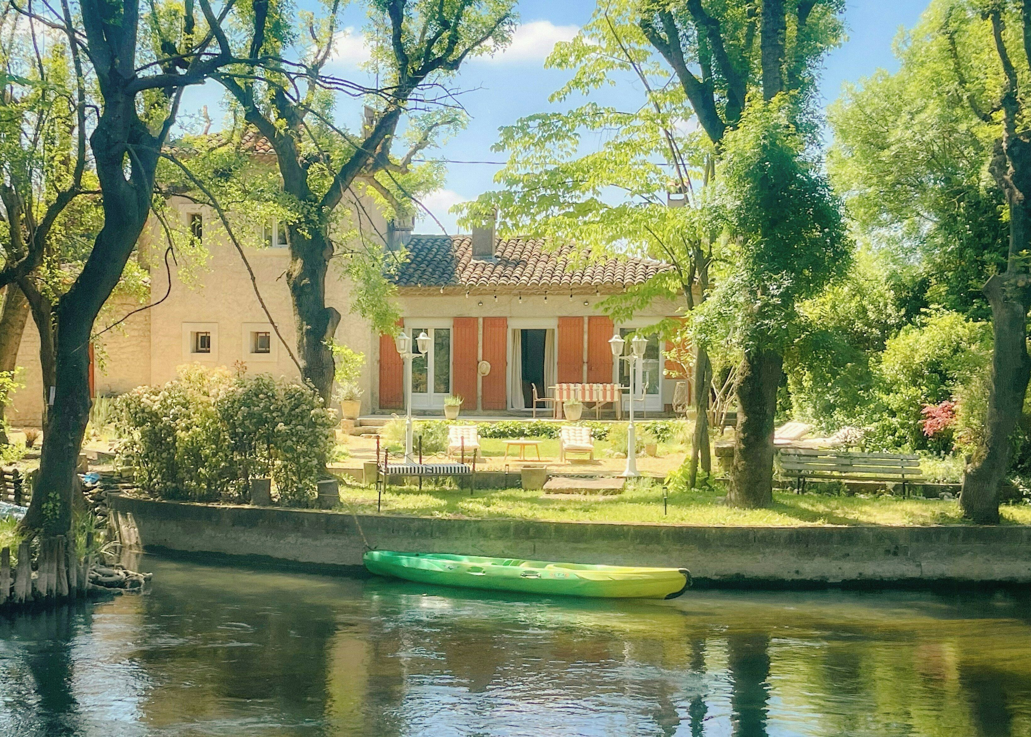 A house with a garden and a river.