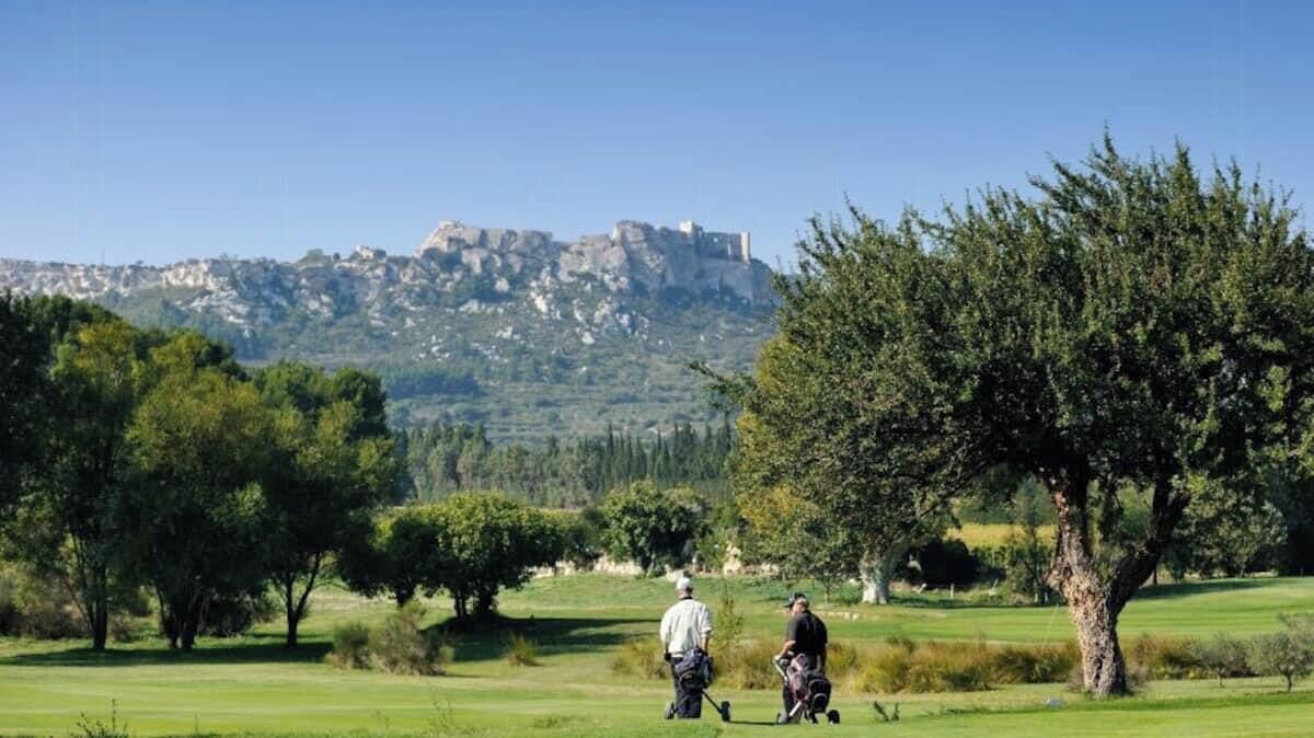 A golf course with a castle in the background.