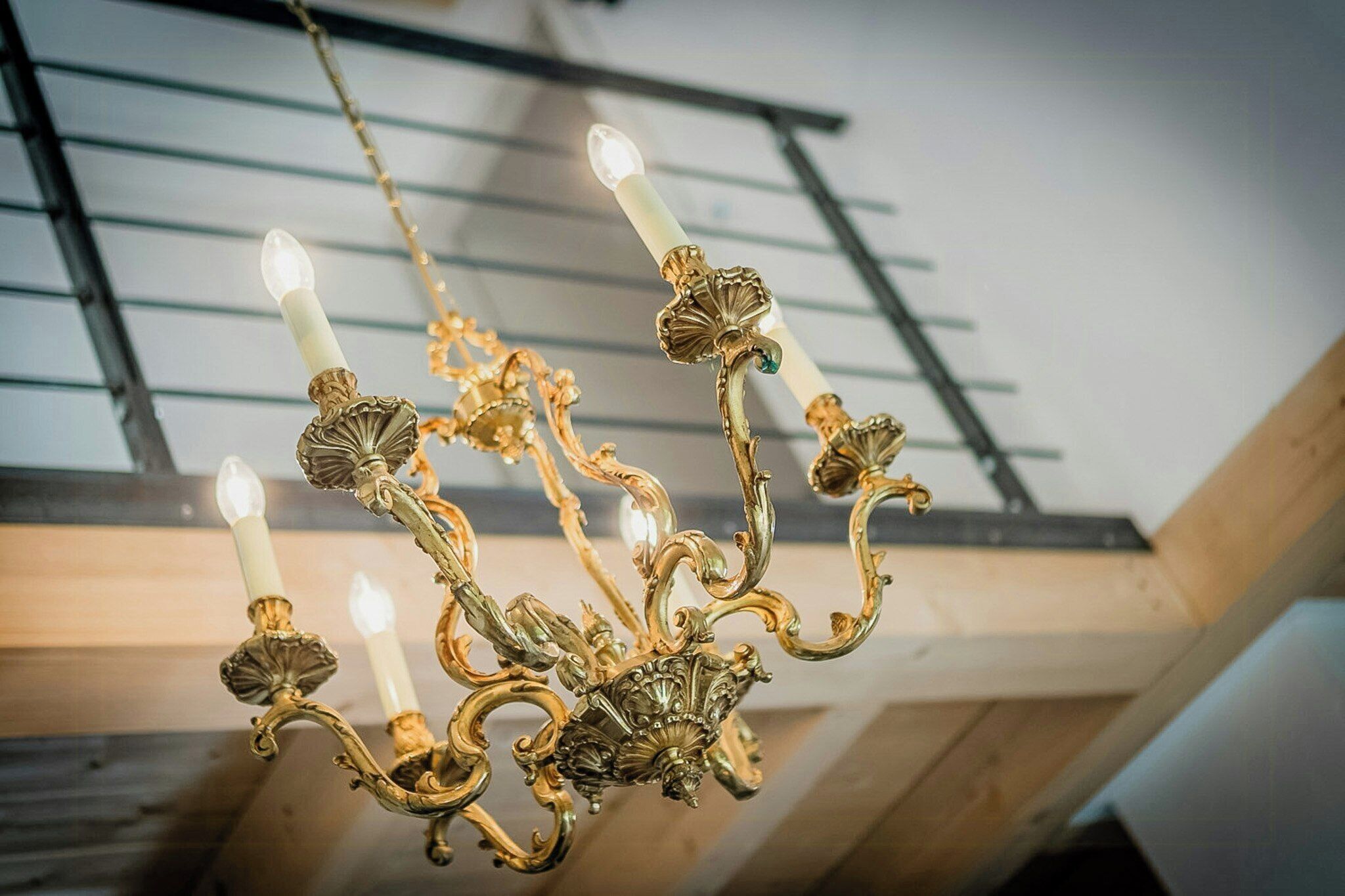 A chandelier with multiple arms and candle-like lights.