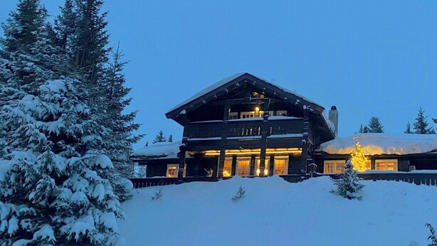 A large log cabin with multiple levels, surrounded by snow-covered trees. - Spacious family cabin with views in Hafjell (Øyer)