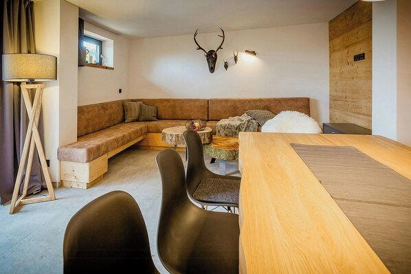 Un espacio de estar acogedor con sofá, mesa de comedor y sillas.