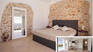A bedroom with a stone wall, a large bed, a nightstand, and a view through an open door. - Historic villa overlooking Scopello sea stacks (Castellammare del Golfo)