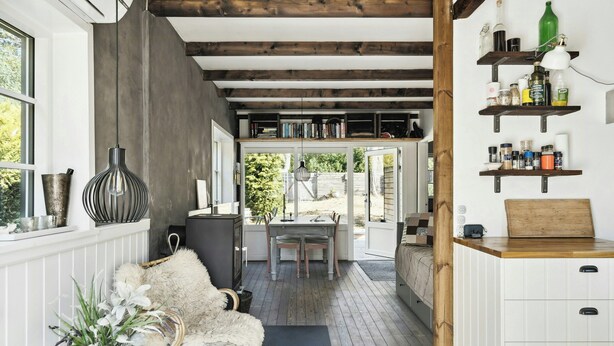 A modern kitchen with wooden beams, white cabinetry, and a dining area with a view. - Modern summer house near Udsholt Beach (Græsted)